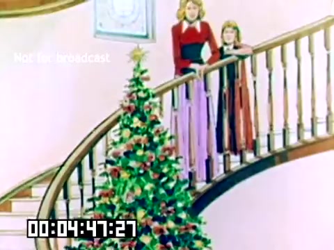 The still shows two women—a mother and daughter—gazing down from a staircase at a beautifully decorated Christmas tree. The setting features warm, pastel colors typical of the 1970s. The staircase is wooden with a classic design, and the presence of holiday decorations suggests a festive atmosphere. A timestamp is visible at the bottom of the image, indicating the duration of the scene. The overall vibe is nostalgic and cheerful, capturing a holiday moment.