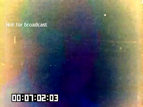 The still appears to show a muted, somewhat blurred frame from a 16mm film, likely exhibiting age-related wear and color fading. The text 'Not for broadcast' is prominently displayed, indicating the film's restricted usage. A timestamp is visible in the lower left corner, marking the footage at 7 minutes and 2 seconds. The overall impression is one of nostalgia and the vintage quality typical of a promotional film from 1977.