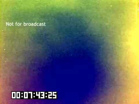 The still from the 16mm silent Kodak sales film features a colorful, abstract background with a gradient that transitions from green to blue and yellow tones. Text reading 'Not for broadcast' is prominently displayed, indicating the film's restricted usage. A timer is visible at the bottom, showing a timestamp of 7 minutes and 43 seconds. The overall composition suggests a promotional or behind-the-scenes context related to Kodak's products, with a nostalgic aesthetic reflective of the 1970s.