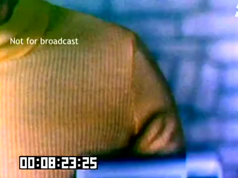 The still features a close-up of a man wearing a bright yellow sweater, with a blurred background likely related to a sales presentation or promotional setting. The image has a timestamp at the bottom and a 'Not for broadcast' label, indicating it was intended for internal use only. The overall composition suggests a casual yet focused atmosphere typical of promotional materials from the 1970s.