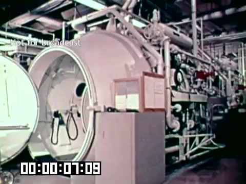 This still features a large, industrial hyperbaric chamber used in medical settings. The chamber is cylindrical and shows equipment associated with its operation. The context suggests it is part of a presentation on preventing gangrene and enhancing survival rates through advanced medical technologies, likely in relation to military or emergency medical services. The overall environment appears to be a clinical or research facility focused on trauma care.