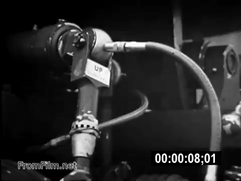 The still depicts equipment from a CH-54 helicopter, likely focusing on mechanics pertinent to its operation. Hoses and piping are visible, emphasizing the technical aspects of military aviation during the Vietnam War era. This PSA aims to highlight the role of flight engineers, like Specialist 6 James Daly, and the essential yet often overlooked work that supports military operations. The black-and-white imagery captures the stark realities of army life, portraying the machinery essential for missions.