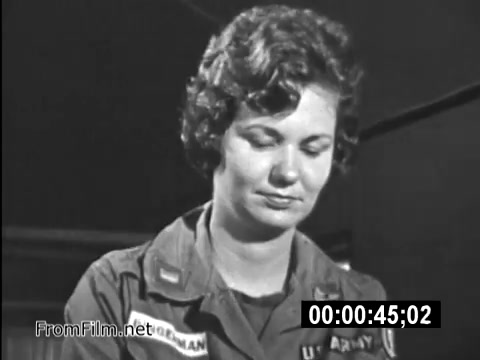 The 16mm still from 'Your Man In Vietnam' features a U.S. Army service member, identified as a female wearing a military uniform with insignia. She appears focused and somber, embodying the everyday experiences of military life during the Vietnam War era. This public service announcement highlights the reality faced by American service members and their roles, emphasizing the human element in the military amidst the conflict. The footage serves as a reminder of the personal sacrifices and responsibilities carried by those in service during this historical period.