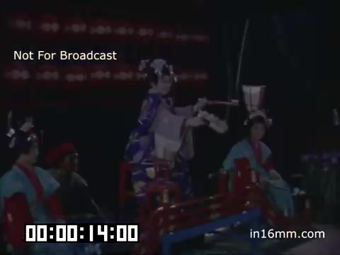 The still is from a promotional segment for 'An Evening in Tokyo,' a show sponsored by Pan Am and aired on NBC in 1963. The program likely highlighted Japanese culture through performances, showcasing traditional attire and arts, as indicated by the presence of performers in elaborate costumes. The promo conveys a sense of cultural celebration and travel allure that was prevalent during this period, especially with the rise of international travel. The film elements were recovered from MovieLab NYC, indicating efforts to preserve vintage television history.