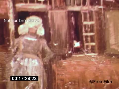 The still from 'Vincent Van Gogh: A Self-Portrait' (1961) features a painterly depiction of a woman in a light-colored dress, looking towards a window or doorway. The vibrant colors and expressive brushstrokes capture the emotional intensity typical of Van Gogh’s style. The scene conveys a sense of introspection and possibly longing, set against a textured background evocative of his artwork. Lee J. Cobb's narration likely adds depth to this visual portrayal of Van Gogh’s life and artistic journey.