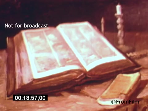 The still from 'Vincent Van Gogh: A Self-Portrait' (1961) features an open book resting on a table, with a soft, warm light illuminating its pages. Beside the book, there is a slender candle casting a gentle glow, contributing to the contemplative atmosphere. This intimate setting may evoke themes of reflection and artistry, resonating with Van Gogh's exploration of self. The image captures the mood of the film, highlighting the connection between creativity and solitude.