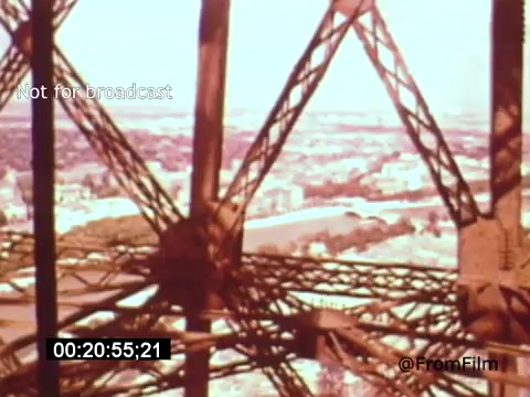 The still from 'Vincent Van Gogh: A Self-Portrait (1961)' features a close-up view of the intricate iron lattice structure of the Eiffel Tower, showcasing the architectural details above and the expansive cityscape below. The vibrant colors evoke a sense of nostalgia, enhancing the film's artistic exploration of Van Gogh's life and legacy. Lee J. Cobb’s narration complements the visuals, providing context to Van Gogh's emotional journey.