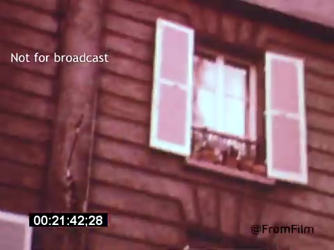 The still from 'Vincent Van Gogh: A Self-Portrait' (1961) features a close-up of a window with closed shutters, set against a textured wooden wall. The light appears to filter through, creating a soft ambiance. This intimate detail invites viewers to ponder the artist's solitude and emotional depth, reflecting the themes of Van Gogh's life and work.