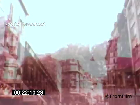 The still from 'Vincent Van Gogh: A Self-Portrait' (1961) showcases an impressionistic portrayal of a street scene, likely representing Van Gogh's influences on urban landscapes. The image features a soft, dreamlike quality with muted colors and blurred edges, creating an ethereal atmosphere. This artistic choice reflects Van Gogh's unique style and emotional depth, while Lee J. Cobb's narration likely adds a rich, engaging layer to the storytelling.