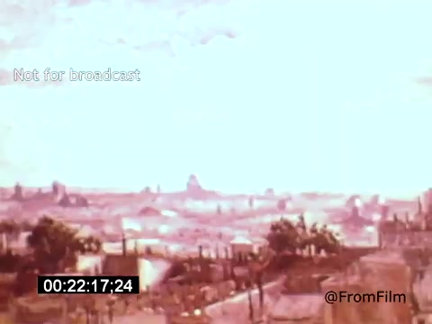 The still from 'Vincent Van Gogh: A Self-Portrait' (1961) showcases a landscape view with soft, muted colors. The composition features rolling hills and distant structures, likely inspired by Van Gogh's own works. The scene conveys a serene, almost dreamlike quality, reflecting the artist's emotional connection to his surroundings. The timestamp and watermark suggest it is a preserved segment, emphasizing its historical significance.