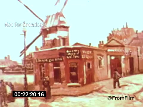 The still from 'Vincent Van Gogh: A Self-Portrait' (1961) features a vibrant scene showcasing a windmill in the background and a quaint building in the foreground, likely reflecting the artist’s surroundings. The pastel colors and impressionistic style echo Van Gogh's distinct artistic approach. This film, narrated by Lee J. Cobb, explores Van Gogh's life and work, capturing the essence of his influence on art.