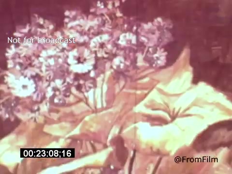 The still from 'Vincent Van Gogh: A Self-Portrait' (1961) features a close-up of vibrant flowers alongside textured foliage. The colors are rich and warm, reflecting Van Gogh's expressive style. This scene likely underscores the artist's connection to nature, as well as his unique approach to capturing the world around him. Lee J. Cobb's narration may enhance the viewer's understanding of Van Gogh's life and artistic vision.