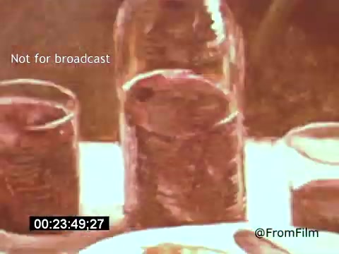 The still from 'Vincent Van Gogh: A Self-Portrait' (1961) features a close-up of glass jars on a table, capturing their textures and reflections. The warm colors and soft focus create an impressionistic atmosphere, echoing Van Gogh's artistic style. This moment emphasizes the film's exploration of Van Gogh's life and work, presented with a rich visual aesthetic.