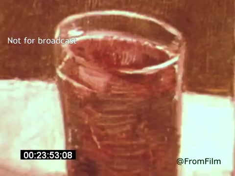 The still from 'Vincent Van Gogh: A Self-Portrait' (1961) features a close-up of a glass, capturing its textures and the interplay of light and color. The image evokes Van Gogh's distinctive brushwork and painterly style, reflecting themes of emotion and perception, likely accompanied by narration or commentary from Lee J. Cobb. The film explores Van Gogh's artistic journey and inner struggles.