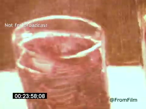 The still from 'Vincent Van Gogh: A Self-Portrait' (1961) features a close-up of a glass, likely capturing a moment of reflection or introspection. The lighting creates a warm, hazy effect, suggesting a contemplative atmosphere. This shot conveys the emotional depth of the film, enhancing the portrayal of Van Gogh's creative spirit.