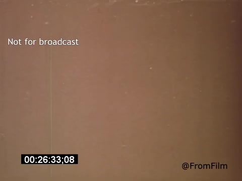 The still from 'Vincent Van Gogh: A Self-Portrait' (1961) captures a muted, textured background, likely representing the film's artistic approach to Van Gogh's life. The image features a timecode, signaling it's a frame from the film and 'Not for broadcast' indicates it's meant for internal use. The presence of Lee J. Cobb suggests a narration or performance that adds depth to Van Gogh's story. Overall, the still conveys an intimate look into the artist's persona.