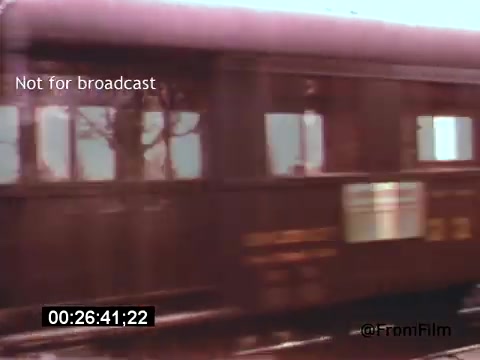 This 16mm still from 'Vincent Van Gogh: A Self-Portrait' (1961) features a blurred view of a train car moving past, capturing a moment in motion. The color palette suggests a vintage aesthetic, and the presence of trees in the background adds to the scene's depth. This still evokes a sense of travel and transition, possibly reflecting Van Gogh's own journey through art and life. The film features Lee J. Cobb, hinting at a narrative that bridges the past and personal introspection.