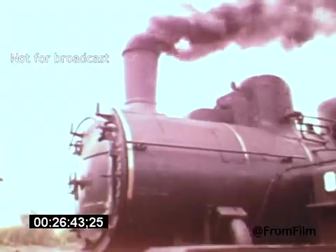 The still from 'Vincent Van Gogh: A Self-Portrait (1961)' features a steam locomotive, showcasing a prominent black engine with a large smokestack emitting steam and smoke. The image is tinted in soft colors, contributing to a nostalgic ambiance. This moment captures the intersection of art and industrialism, often reflecting Van Gogh's themes of movement and change. The film features narration by Lee J. Cobb, adding to its artistic interpretation.