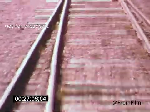 The still from 'Vincent Van Gogh: A Self-Portrait (1961)' features a close-up of railway tracks extending into the distance. The image captures the texture of the wooden ties and the metallic rails, possibly symbolizing Van Gogh's turbulent journey through life. The overall composition conveys a sense of isolation and reflection, aligning with themes of the film and the artist's experiences.