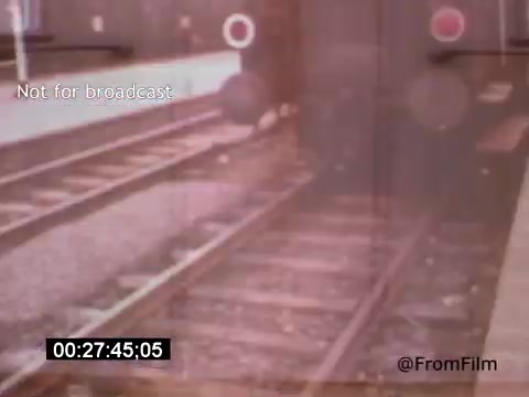 The still from 'Vincent Van Gogh: A Self-Portrait' (1961) appears to depict a railway scene, showing train tracks alongside a station. The image is likely infused with a nostalgic or artistic aesthetic typical of 16mm film, possibly reflecting the themes of journey and introspection related to Van Gogh's life and work. The visual elements may also convey a sense of isolation or transition, resonating with the broader narrative of the film.