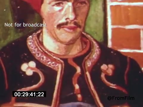 The still from *Vincent Van Gogh: A Self-Portrait (1961)* features an artistic representation of Vincent Van Gogh, showcasing bold colors and expressive brushwork typical of his style. The subject, depicted with a mustache, is wearing a distinctive jacket adorned with decorative patterns, capturing the essence of Van Gogh’s unique artistic vision. The background includes simple, contrasting elements that enhance the overall composition.