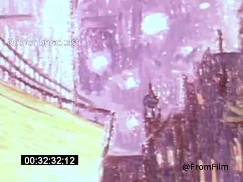 The 16mm still from 'Vincent Van Gogh: A Self-Portrait' (1961), featuring Lee J. Cobb, captures a vivid, impressionistic scene. The image showcases swirling colors and abstract shapes, reminiscent of Van Gogh's style, possibly depicting a nighttime cityscape. The warm yellows contrast with cooler hues, suggesting vibrancy and emotion, while the presence of light spots could symbolize stars or reflections, contributing to a sense of depth and movement. The frame indicates this is part of a larger narrative focused on the artist's life and work.