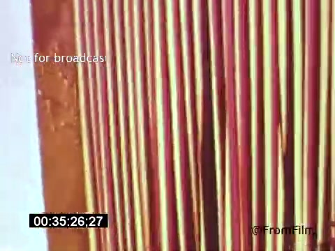 The still from 'Vincent Van Gogh: A Self-Portrait' (1961) features a close-up view of textured surfaces with vertical stripes in varying shades of red and yellow. The image captures the essence of Van Gogh's vibrant color palette, possibly referencing his unique brushwork and artistic style. The timestamp indicates a moment within the film, emphasizing the visual intricacies used to explore the artist's life and work through the narration of Lee J. Cobb.