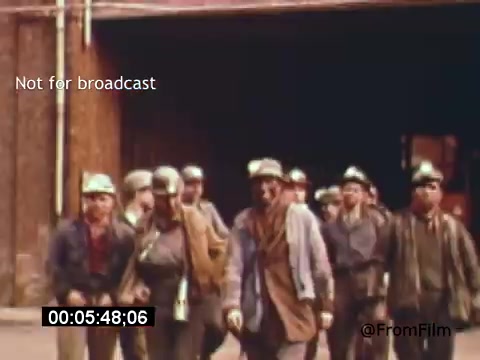 The still from 'Vincent Van Gogh: A Self-Portrait' (1961) features a group of miners in a rustic setting, likely emerging from a mine. They wear hard hats and work attire, suggesting a grueling day of labor. The ambiance conveys a sense of camaraderie among the workers, with muted colors reflecting the somber yet resilient spirit of their environment. Lee J. Cobb’s narration likely drives the emotional depth, connecting Van Gogh's artistic legacy to the shared experiences of such laborers.