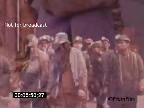 The still from 'Vincent Van Gogh: A Self-Portrait' (1961) features a group of men, likely in a working-class setting, dressed in muted clothing. Their expressions appear serious or contemplative, evoking an atmosphere of toil and struggle. The film, narrated by Lee J. Cobb, explores Van Gogh's life and art through a unique lens, emphasizing the emotional weight of the artist's experiences. The visual style combines color and texture to reflect the period’s aesthetic. The overlay text indicates the image is not intended for broadcast.