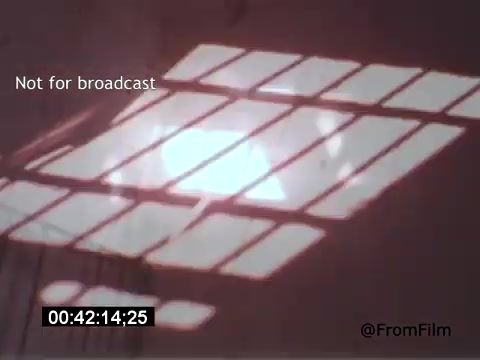 The still from 'Vincent Van Gogh: A Self-Portrait' (1961) depicts a reflective surface, possibly a floor or wall, illuminated by sunlight filtering through a grid of window panes. The interplay of light and shadow creates a visually striking composition, emphasizing texture and depth. This moment highlights the introspective nature of the film, evoking the artist's emotional landscape.