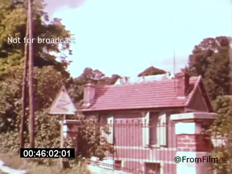 The 16mm still from 'Vincent Van Gogh: A Self-Portrait (1961)' features a quaint house with a red tiled roof, surrounded by lush greenery. A warning sign can be seen nearby, suggesting a rural or historical setting. The image captures a serene, almost nostalgic atmosphere, reflecting the artistic spirit of Van Gogh. The film, narrated by Lee J. Cobb, explores the life and struggles of the renowned painter.