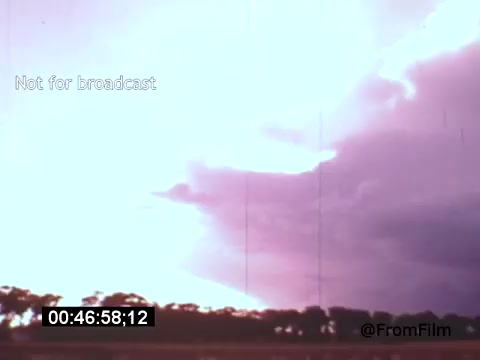 The 16mm still from 'Vincent Van Gogh: A Self-Portrait' (1961) features a dramatic sky dominated by swirling clouds, illuminated by soft light. The colors exhibit a mix of purples and blues, creating an atmospheric and somewhat turbulent scene. This moment captures the essence of Van Gogh's emotive style, reflecting the intensity of nature and possibly paralleling the artist’s own inner turmoil. The text overlay indicates it’s not for broadcast.