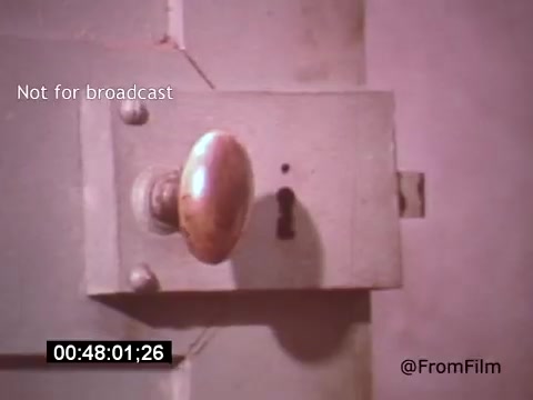 The still from **'Vincent Van Gogh: A Self-Portrait' (1961)** features a close-up of a door lock. The brass doorknob glimmers with a subtle shine, while the muted colors of the surrounding area suggest a somber, introspective atmosphere. This shot likely symbolizes themes of confinement or introspection, aligning with Van Gogh's own struggles. The presence of a timestamp and 'Not for broadcast' watermark indicates it is part of a larger film piece, perhaps focusing on Van Gogh's life and artistic journey.