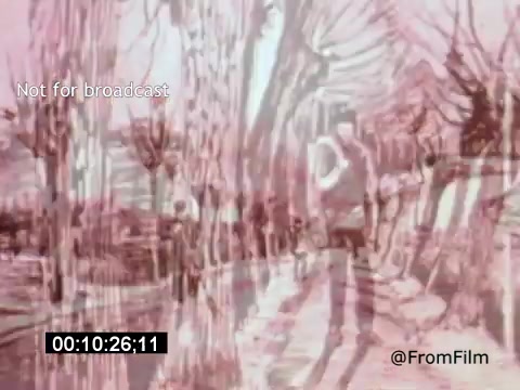 The still from 'Vincent Van Gogh: A Self-Portrait (1961)' features a blurred, impressionistic scene that evokes Van Gogh's distinctive painting style. The image showcases a figure walking along a tree-lined path, with swirls and colors that mimic the artist's emotional use of brushwork. This aesthetic emphasizes the subjective experience, reminiscent of Van Gogh’s tumultuous life and artistry. The presence of a timecode and “Not for broadcast” watermark suggests it is part of an archival or behind-the-scenes footage.