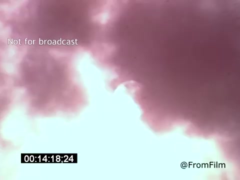 The 16mm still from 'Vincent Van Gogh: A Self-Portrait' (1961) appears to capture a dramatic, ethereal image, likely depicting a sky filled with billowing clouds in shades of purple and white. This visual may evoke the turbulent emotions associated with Van Gogh's life and work. The muted colors and soft focus contribute to a dreamlike atmosphere, reflecting the introspective nature of the film, narrated by Lee J. Cobb.