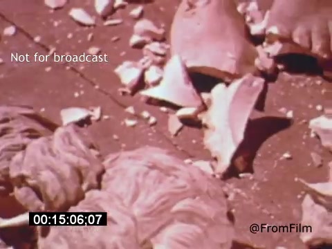 The still from 'Vincent Van Gogh: A Self-Portrait (1961)' captures a close-up of broken ceramics or porcelain pieces scattered on a surface. The focus appears to be on the textures and details of the shards, possibly symbolizing fragility or destruction. The muted tones and the composition evoke a sense of stillness, connecting to themes often explored in Van Gogh's works. The film features Lee J. Cobb, lending a dramatic narrative to the visual presentation.