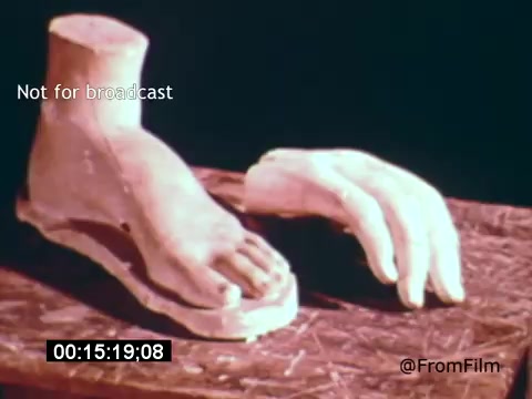 The still from 'Vincent Van Gogh: A Self-Portrait (1961)' features a sculptural representation of a foot and a hand, suggesting the influence of anatomy in Van Gogh's art. The hands are positioned on a textured surface, hinting at a connection to the physicality of art-making. The overall composition emphasizes the tactile nature of artistic expression, resonating with Van Gogh's own approach to painting. The film likely explores themes of creativity and the artist's psyche, narrated by Lee J. Cobb.