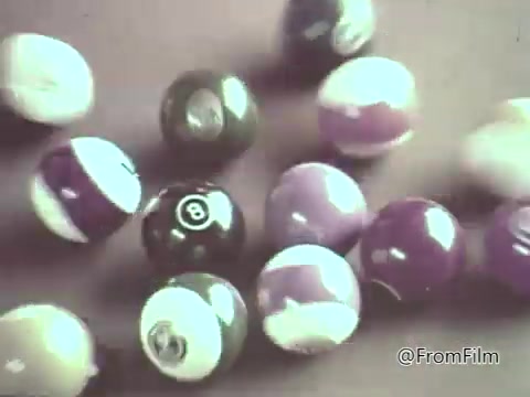 The still likely features animated M&M's candies depicted in a playful and colorful manner, characteristic of 1960s commercials. The visual style may include vibrant, round candies with bright colors, possibly interacting with various elements, highlighting their fun and whimsical nature. The charm of the animation reflects the lighter, humorous advertising style of that era, aiming to attract viewers' attention and evoke a sense of enjoyment associated with M&M's.