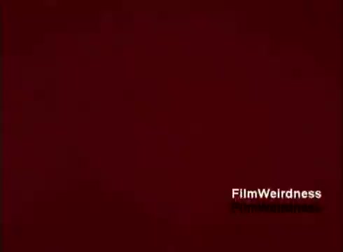 The still likely features a rich, deep color background, possibly red, with a title that references 'Film Weirdness.' The content is a nostalgic look at the Bell System, focusing on the creation and assembly of telephones. This film captures technological innovation from the 1970s, reflecting on the era's telecommunications advancements without introductory or concluding titles, enhancing its archival charm.