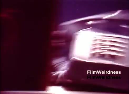 The 16mm still from 'Bell System Film from the 1970s' captures a blurred image of telephones, likely highlighting the manufacturing process or design features. The focus seems to be on the movement and production aspects, emphasizing the technological nostalgia of the Bell System era. The shot conveys a dynamic feel, possibly showcasing the assembly line or a close-up of the telephone components. Overall, it reflects a moment of mid-20th-century communication technology history.