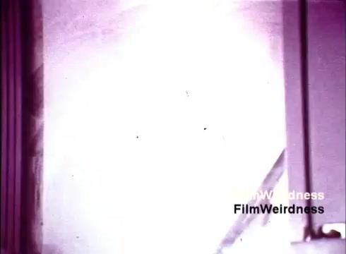 The still appears to capture a vibrant yet unclear moment from the 1970s Bell System film, likely focusing on the manufacturing process of telephones. The lighting seems bright, potentially highlighting machinery or the assembly environment. There may be remnants of film grain or age-related artifacts, adding to its nostalgic charm. Overall, it evokes a sense of curiosity about the technology and craftsmanship of that era.