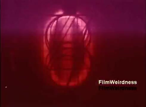 The still from the 16mm film 'Bell Performance' features an abstract, reddish hue, depicting a shape reminiscent of a telephone or electrical component. The focus seems to be on the intricacies of telecommunications technology, capturing a blend of nostalgia and industrial design. The background adds a textured feel, enhancing the sense of depth and complexity associated with the manufacturing process of telephones in the 1970s.