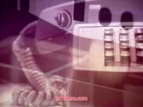 The still from the 16mm film 'Performance' features a close-up of a vintage telephone, likely a rotary or early keypad model. The image has a soft focus and may display a muted color palette characteristic of films from the early 1970s. The composition suggests a blend of the abstract and the mundane, possibly reflecting themes of communication or connection. The end titles indicating production details, including the date and cast, frame this moment within the context of its release.