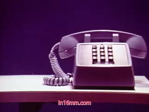 The still depicts a classic rotary phone sitting on a table against a purple background, suggesting a retro aesthetic typical of the early 1970s. This moment likely captures a concluding scene or segment in the film “Performance,” highlighting themes of communication and technology. The surrounding ambiance emphasizes the phone, creating a sense of focus, with the end titles providing crucial information about the production's date and its cast and crew.