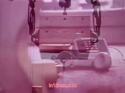 The still from 'Performance' - a Bell System Film from 1971 features a combination of phone equipment and telecommunication imagery, likely showcasing elements related to the film's themes. The tones are soft and possibly faded, characteristic of 16mm prints. This particular frame serves as an end title, indicating the production date and listing cast and crew, encapsulating the film's conclusion.