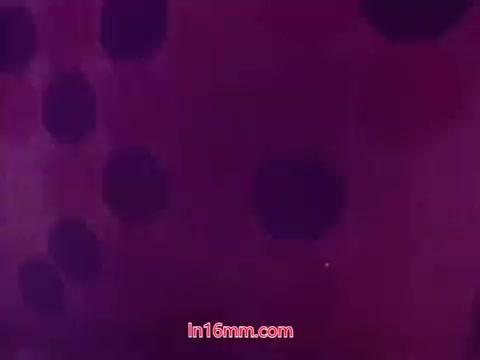 The 16mm still from 'Performance' - Bell System Film (1971) features a textured background with abstract shapes, likely in varying shades of purple and black. The end titles reveal the production date along with the names of the cast and crew. This segment marks the conclusion of the film, providing essential credit information while maintaining a visually striking aesthetic characteristic of its era.