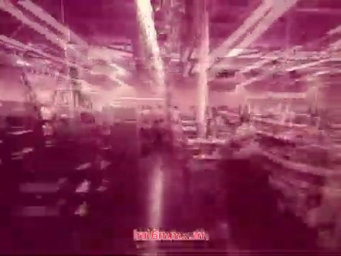 The still from 'Performance' (1971) features a stylized, abstract representation of an industrial setting, drenched in shades of pink. The lighting creates a dynamic interplay of shadows and highlights, suggesting a bustling, active environment. The bottom of the image includes end titles that outline the production date, cast, and crew involved in the film, signifying the conclusion of the piece. The overall aesthetic reflects the film's experimental nature, encouraging a sense of both movement and intrigue.