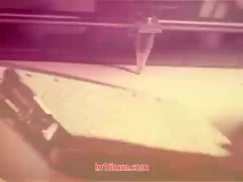 The still from the 16mm film 'Performance' – Bell System Film from 1971 captures a close-up of a typewriter and a sheet of paper. The scene likely evokes a sense of nostalgia, with soft colors and a blurred focus typical of vintage film. The image suggests a moment of writing or recording, hinting at themes of communication and expression, which are relevant to the film's context. This still may serve as a visual element in the end titles, indicating production details and credits.