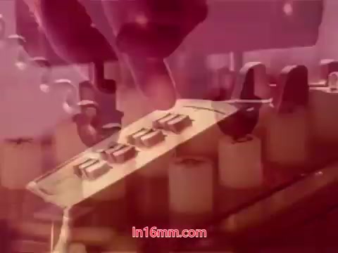 This still from the 16mm film 'Performance' (1971) depicts a hand engaged with a vintage phone's rotary dial, emphasizing the tactile interaction with the technology of the time. The background features a blurred, abstracted view of the phone's components, creating a layered visual effect. The color palette appears warm, possibly hinting at nostalgia. The context suggests this is from the end titles, which likely include production details, cast, and crew acknowledgments.