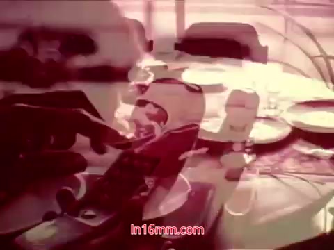 The still from 'Performance' – a Bell System Film from 1971 – features a close-up of a hand interacting with a vintage telephone. The background suggests a domestic setting with a table set, while the colors exhibit a faded, nostalgic quality typical of 16mm prints. The attribution of end titles indicates it concludes with production details, including the cast and crew involved, encapsulating a moment from the film's closing sequence.